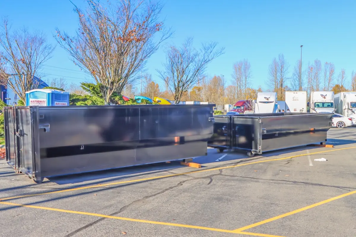 Professional dumpster rental service with roll-off container on residential driveway in Terrell Hills